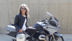 Grey hair model Valeria Sechi in jacket leather with a BMW R1200RT motorcycle