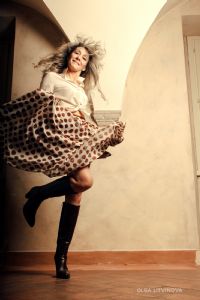 Grey hair model Valeria Sechi wearing a white fashion shirt and a pois skirt