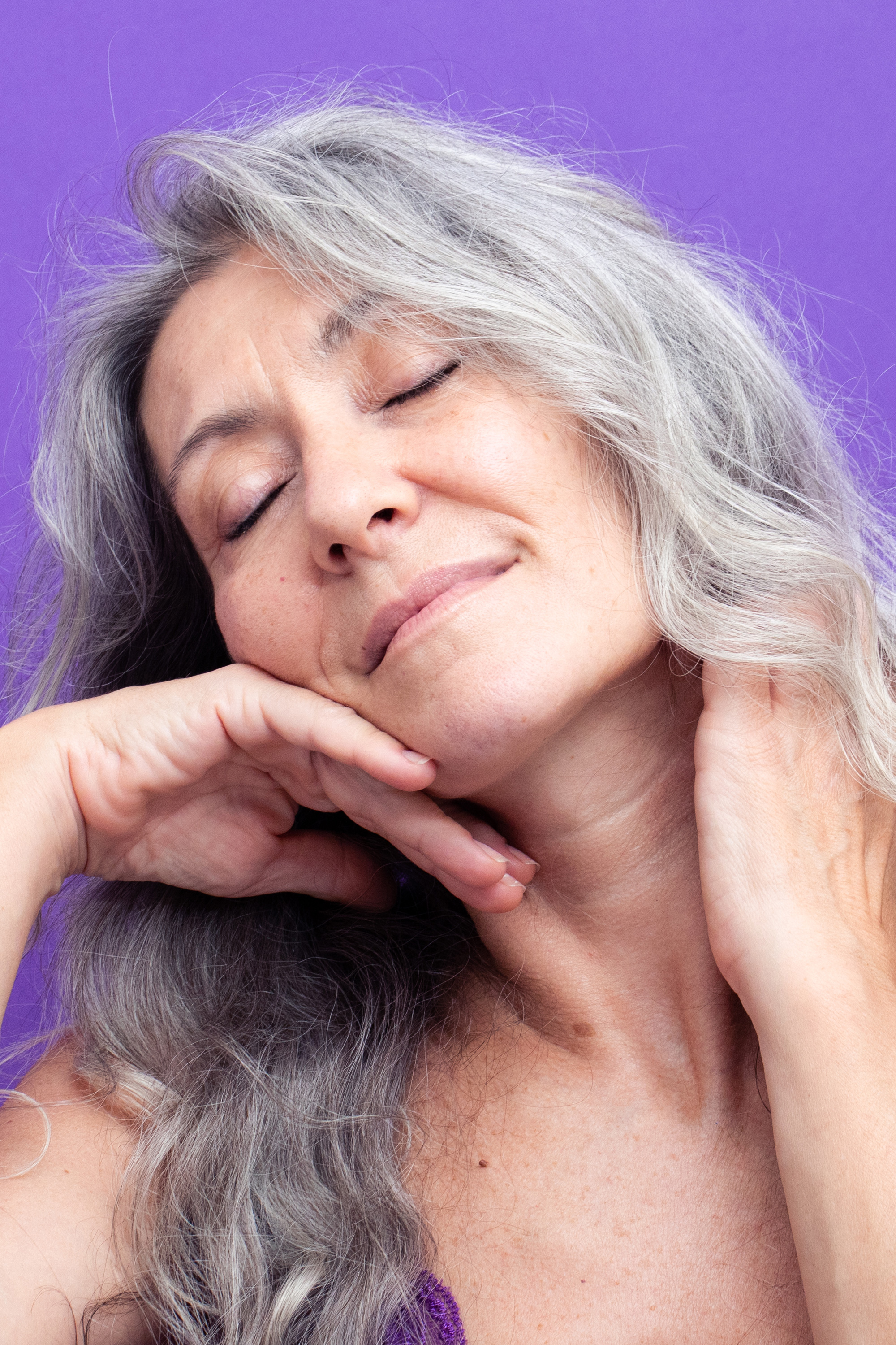 Grey model Valeria Sechi in a shot with purple background for Lace Beauty campaign