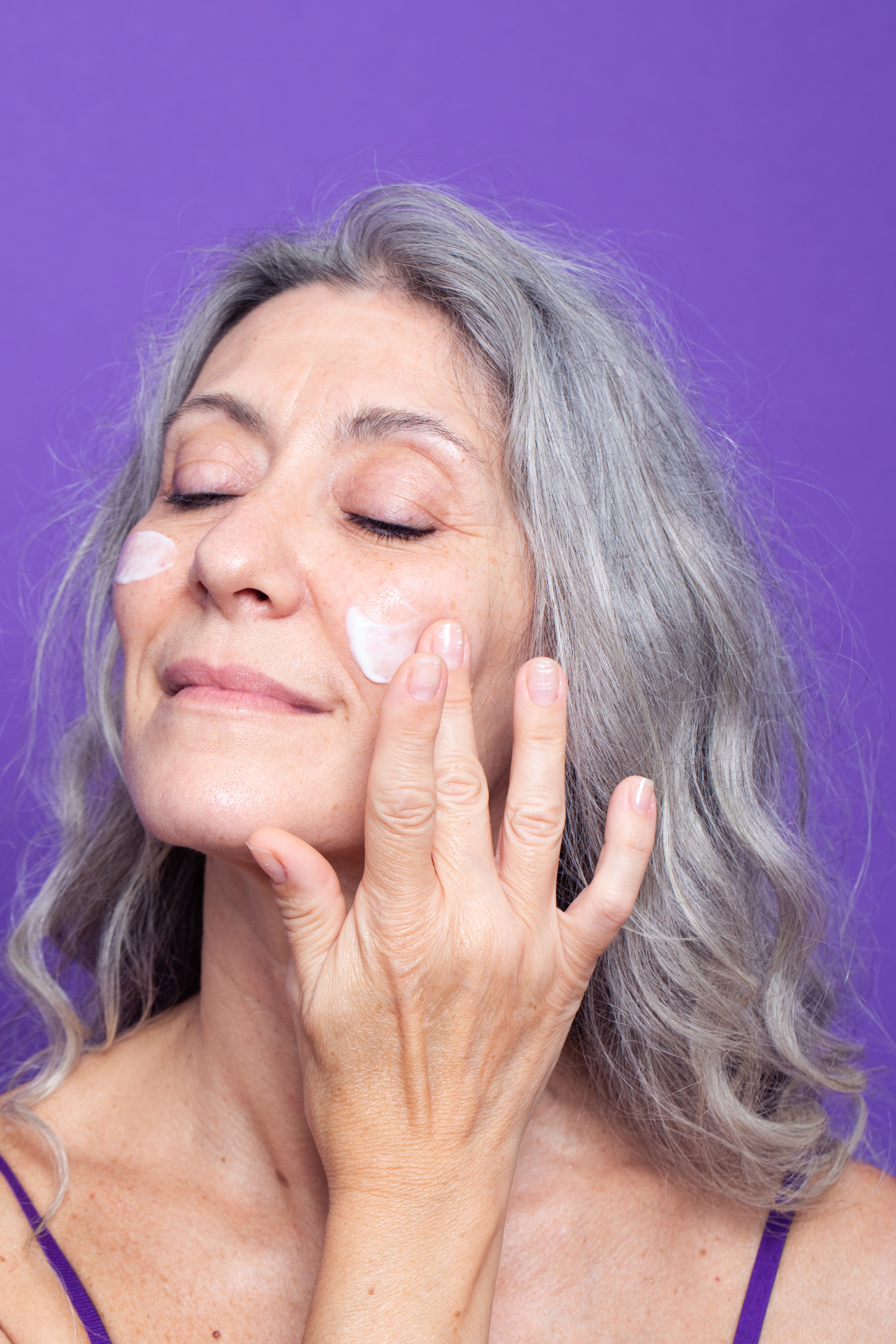 Grey model Valeria Sechi in a shot with purple background for Lace Beauty campaign