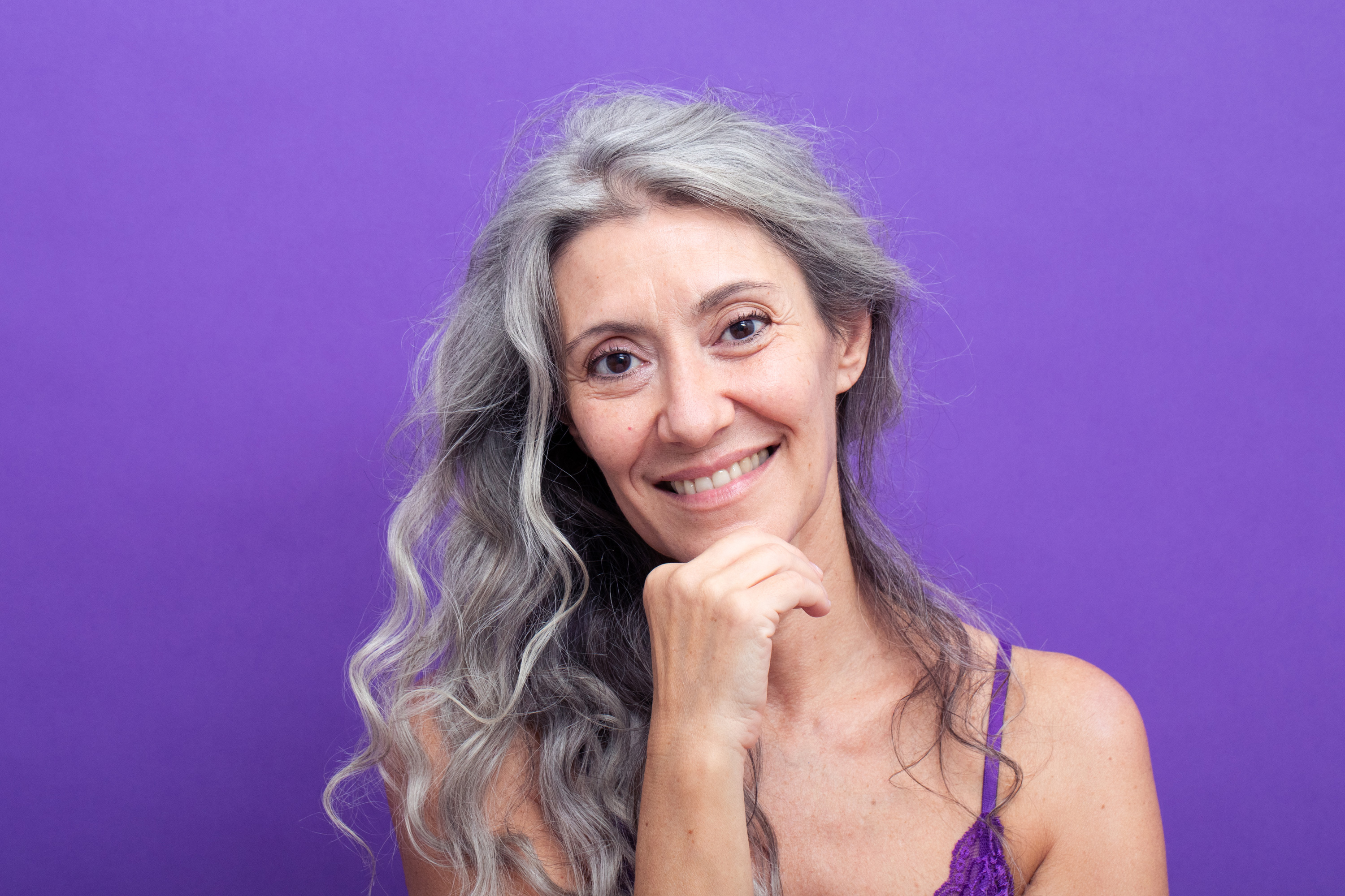 Grey model Valeria Sechi in a shot with purple background for Lace Beauty campaign