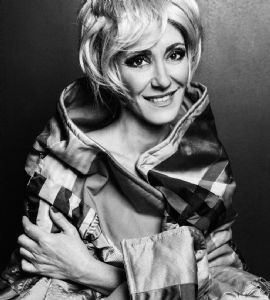 A black and white portrait of grey hair model Valeria Sechi wearing a wig