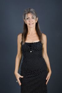 A portrait of grey hair model Valeria Sechi with a pois dress
