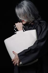 Grey hair model Valeria Sechi posing with a bag