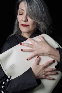 Grey hair model Valeria Sechi posing with a bag