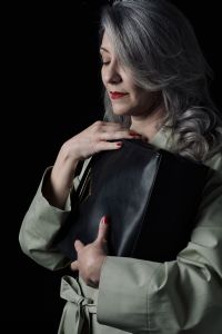 Grey hair model Valeria Sechi posing with a bag