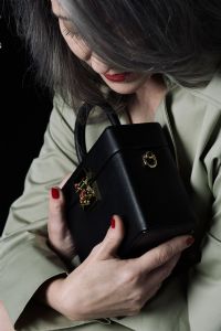 Grey hair model Valeria Sechi posing with a bag