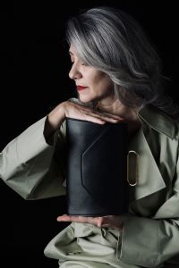 Grey hair model Valeria Sechi posing with a bag