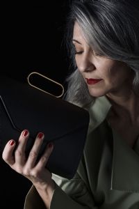 Grey hair model Valeria Sechi posing with a bag