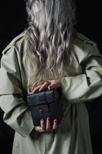 Grey hair model Valeria Sechi posing with a bag