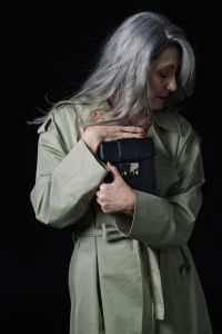 Grey hair model Valeria Sechi posing with a bag