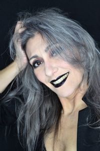 Grey hair model Valeria Sechi wearing a black jacket with dark lipstick