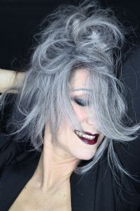 Grey hair model Valeria Sechi wearing a black jacket with dark lipstick