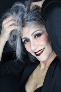 Grey hair model Valeria Sechi wearing a black jacket with dark lipstick