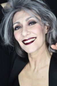 Grey hair model Valeria Sechi wearing a black jacket with dark lipstick