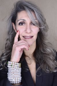 Grey hair model Valeria Sechi wearing a bracelet with pearls