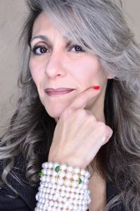 Grey hair model Valeria Sechi wearing a bracelet with pearls