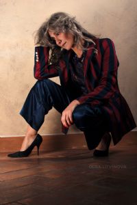 Grey hair model Valeria Sechi wearing a jacket and a blue trousers