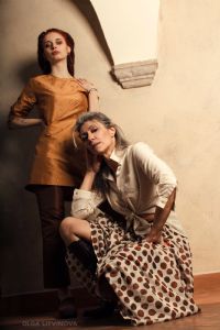 Grey hair model Valeria Sechi wearing a white fashion shirt and a pois skirt