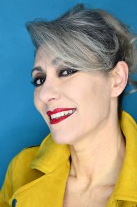 Grey hair model Valeria Sechi wearing a yellow leather jacket