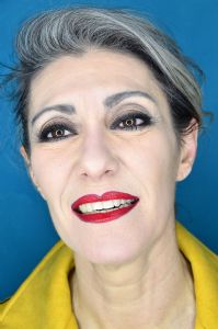 Grey hair model Valeria Sechi wearing a yellow leather jacket