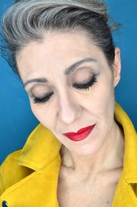 Grey hair model Valeria Sechi wearing a yellow leather jacket