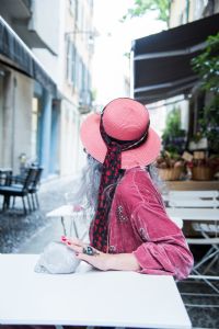 Grey hair model Valeria Sechi wearing pink hat and dress