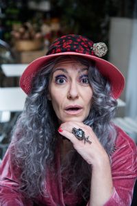 Grey hair model Valeria Sechi wearing pink hat and dress