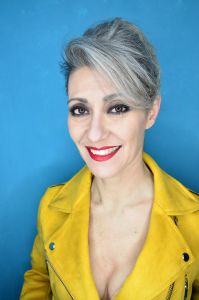 Grey hair model Valeria Sechi wearing a yellow leather jacket