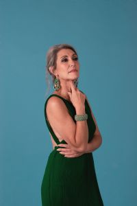 Italian grey hair model Valeria Sechi wearing a green dress