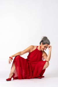 Italian grey hair model Valeria Sechi wearing a red dress