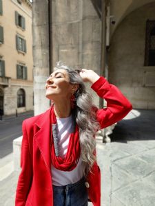 Portrait of Italian grey hair model Valeria Sechi in red jacket