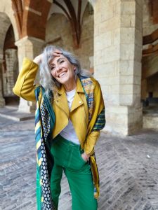 Portrait of Italian grey hair model Valeria Sechi in yellow jacket