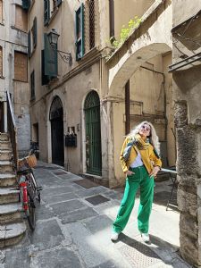 Portrait of Italian grey hair model Valeria Sechi in yellow jacket